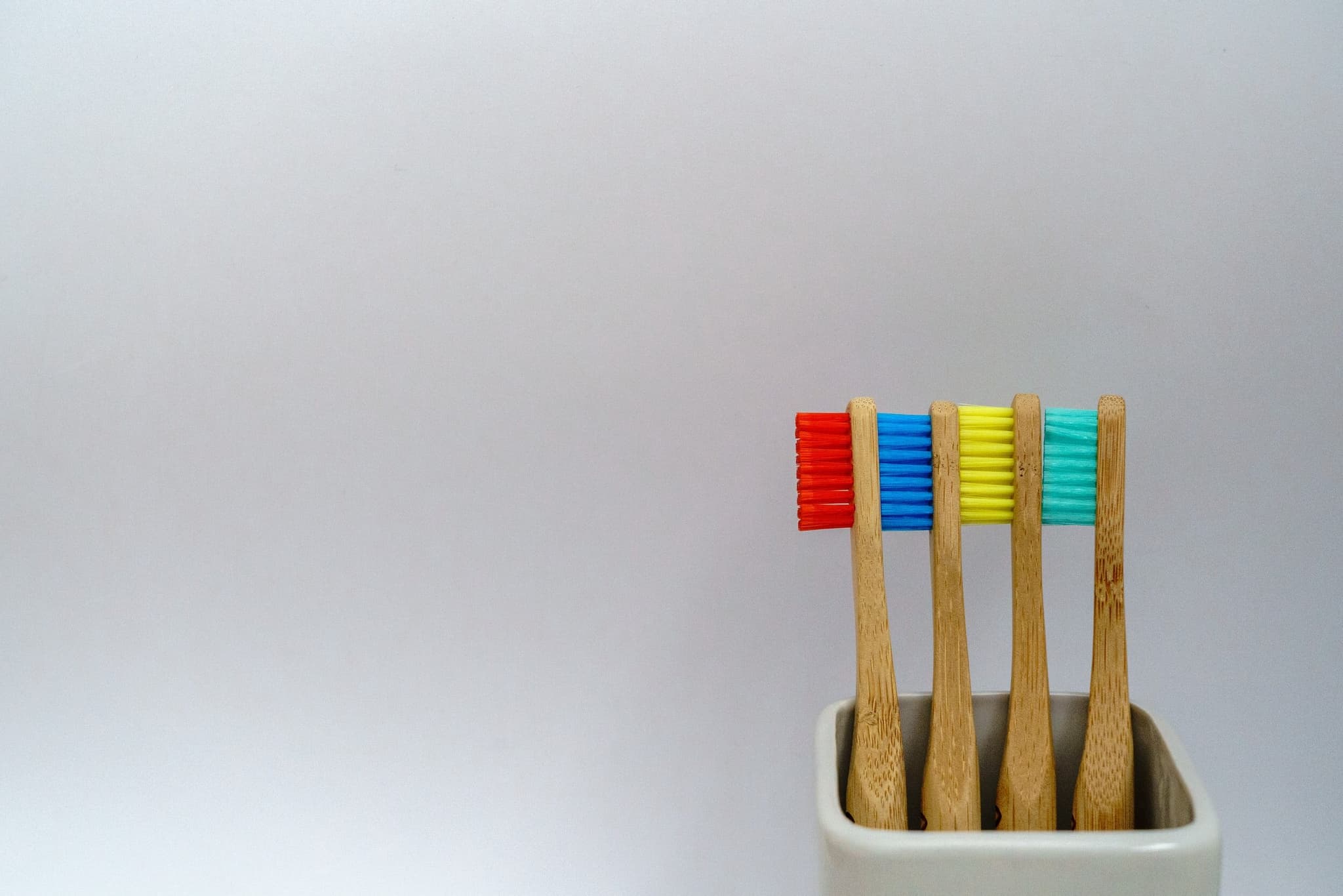 Colorful toothbrushes on gray background